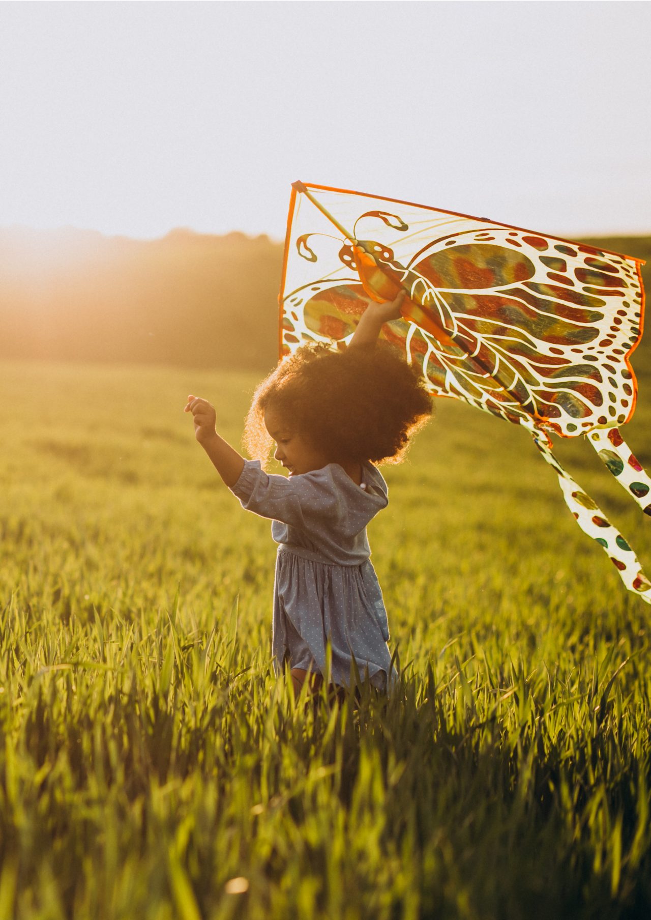 Girl with kite on sunny morning